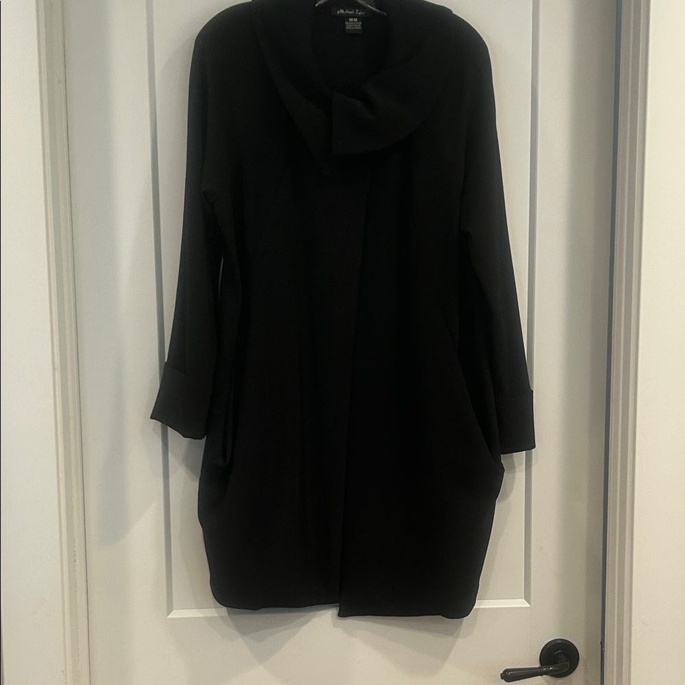 Stylish black single button closure. 3/4 length light weight coat.